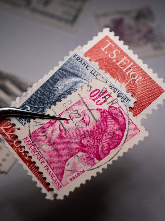 Detailed close-up of a vintage stamp collection, showcasing intricate designs and historical figures.